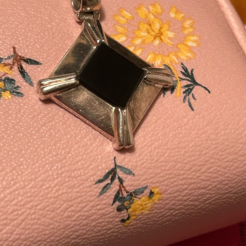 A charm sterling silver on the back it says 950 very unique